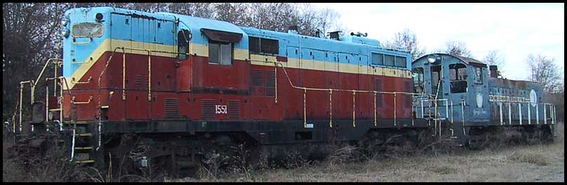 Two rusting diesel locomotives sit in the weeds at Sylvania